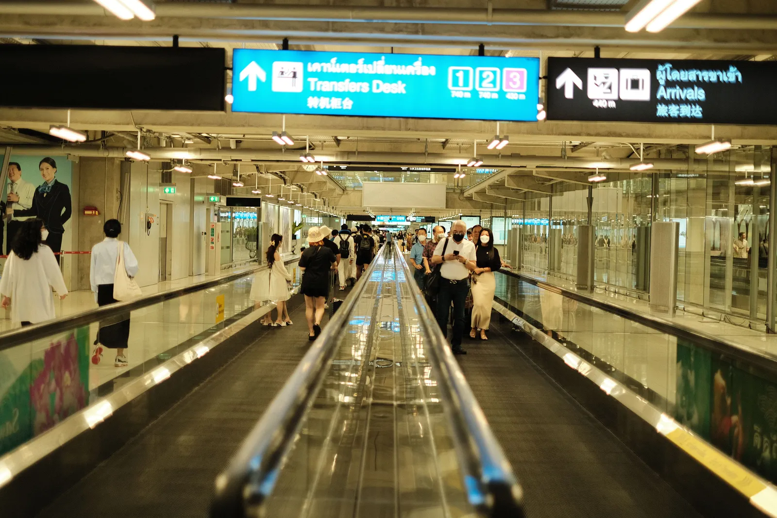 מסוע הליכה בשדה תעופה עם שילוט לדלפק ההעברות ולאולם הנכנסים